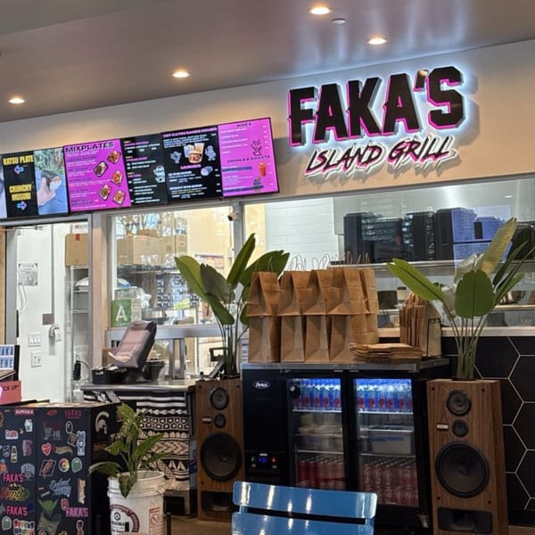Interior of Faka's Island Grill, showcasing the menu boards, counter, and branded decor.